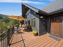 Lovely deck features seating, an umbrella, and mountain views for outdoor enjoyment at 239 Aspen Pl, Evergreen, CO 80439