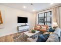 Bright and airy living room with modern decor and large windows overlooking the neighborhood at 2036 S Holly St # 1, Denver, CO 80222