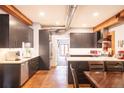Modern kitchen with stainless steel appliances, gray cabinetry, stone countertops, and updated fixtures at 117 Elati St # 1, Denver, CO 80223