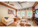 Cozy living room with natural light, wood beams, concrete floors, a cowhide rug, and comfortable seating at 117 Elati St # 1, Denver, CO 80223