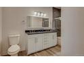 Double vanity bathroom with gray tile and a frameless shower at 14936 E Hampden Ave # 202, Aurora, CO 80014