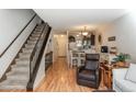 Inviting space with hardwood floors, open staircase, and a glimpse into the kitchen area at 3506 S Depew St # 3, Denver, CO 80235