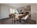 Bright dining area with a rustic wooden table and modern chairs at 4632 S Pagosa Cir, Aurora, CO 80015
