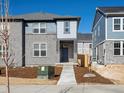 Charming two-story home with gray brick and wood facade on a sunny day at 789 N Tempe St, Aurora, CO 80018