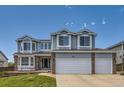 Two-story home with a two-car garage, manicured lawn, and brick accents, and an address on the facade at 10155 Silver Maple Cir, Highlands Ranch, CO 80129