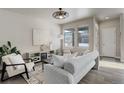 Living room with gray couch, fireplace, and large windows at 6727 Canosa St, Denver, CO 80221