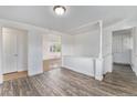 Well-lit living room showcases wood-look floors, white trim, and an open layout with access to other rooms at 588 Empire St, Aurora, CO 80010
