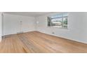 Bright living room with large windows, hardwood floors, and a neutral color scheme at 588 Empire St, Aurora, CO 80010