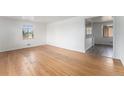Spacious living room featuring hardwood floors, white walls, and ample natural light from a window at 588 Empire St, Aurora, CO 80010