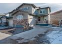 Charming two-story home with stone accents, landscaped yard, and a cozy front porch at 221 Felicity Loop, Castle Rock, CO 80109