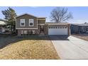 Charming two-story home with brick accents, siding, well-kept lawn, and attached two-car garage at 8408 Wild Alfalfa Pl, Parker, CO 80134