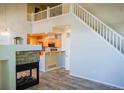 Open-concept living room with adjacent kitchen and unique fireplace feature at 640 S Yarrow St, Lakewood, CO 80226