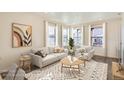 Cozy living room featuring a comfortable sofa, stylish rug, and plenty of natural light at 10331 E 62Nd Pl, Denver, CO 80238