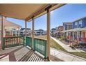 Inviting porch view showcasing neighborhood homes and colorful exteriors on a sunny day at 10331 E 62Nd Pl, Denver, CO 80238