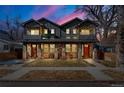 Charming gray duplex with stone accents and front porch at twilight at 4511 Meade St, Denver, CO 80211