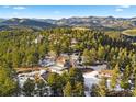 Stunning aerial view showcases a home with mountain vistas and lush greenery at 1056 County Road 65, Evergreen, CO 80439