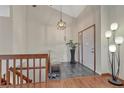 Bright foyer featuring wood floors and an elegant staircase leading to the upper level at 11838 W Arlington Dr, Littleton, CO 80127