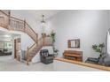 Bright foyer with a staircase, neutral paint, and plants adding warmth to the entrance at 11256 Lima St, Commerce City, CO 80640