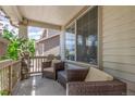 Inviting porch with comfortable wicker furniture, offering a relaxing outdoor space at 11256 Lima St, Commerce City, CO 80640