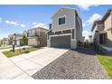 Modern two-story home with a spacious driveway, gray exterior, and manicured landscaping at 16423 Mountain Flax Dr, Monument, CO 80132