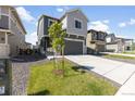 Attractive gray two-story home with a well-maintained lawn, fresh landscaping and a wide driveway at 16423 Mountain Flax Dr, Monument, CO 80132