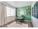 Bright dining area with a large window, unique decor, and hardwood floors at 779 N Deer Park St, Watkins, CO 80137