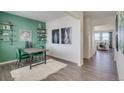 Stylish dining area featuring a modern table, unique decor, and hardwood floors at 779 N Deer Park St, Watkins, CO 80137