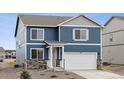 Charming two-story home with a mix of blue siding and stone accents at 779 N Deer Park St, Watkins, CO 80137