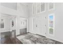 Bright entryway with hardwood floors and view to living room at 9647 Colinade Dr, Lone Tree, CO 80124