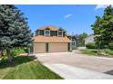 Charming two-story home with a three-car garage, mature trees, and a well-manicured lawn at 603 E 2Nd Ave, Castle Rock, CO 80108