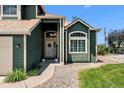 Inviting front entrance featuring a decorative wreath, and well-maintained landscaping at 603 E 2Nd Ave, Castle Rock, CO 80108