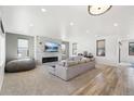Spacious living room featuring a stone fireplace and hardwood floors at 3343 S Newcombe St, Lakewood, CO 80227