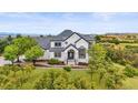 Beautiful home featuring a manicured lawn and mature trees at 1635 Sharps Ct, Castle Rock, CO 80109