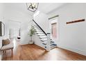 Bright foyer with hardwood floors, staircase, and ample natural light at 3330 W 30Th Ave, Denver, CO 80211