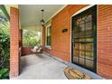 Relaxing front porch with swing, brick columns, and charming details at 3330 W 30Th Ave, Denver, CO 80211