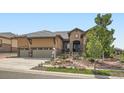 Beautiful home with a well-maintained lawn and a stone and stucco facade, complete with a three-car garage at 15637 Deer Mountain Cir, Broomfield, CO 80023