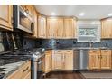 Kitchen with stainless steel appliances and wood cabinets at 11921 W 70Th Pl, Arvada, CO 80004