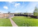 Expansive backyard featuring a lush lawn, basketball court, and additional landscaping at 10405 W 107Th Pl, Broomfield, CO 80021