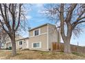 Side view of a quaint two-story home with mature trees in a serene residential neighborhood at 10405 W 107Th Pl, Broomfield, CO 80021