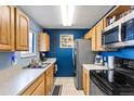 Efficient kitchen layout with modern appliances, ample cabinet space, and durable countertops at 10405 W 107Th Pl, Broomfield, CO 80021