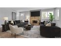 Inviting living room featuring a stone fireplace, comfortable seating, and lots of natural light at 3463 W Bowles Ave, Littleton, CO 80123