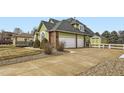 Lovely home featuring three-car garage, tool shed, mature trees and an expansive driveway at 6885 Saddleback Ave, Firestone, CO 80504