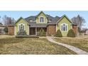 Charming home featuring brick accents, manicured landscaping and an inviting stone pathway at 6885 Saddleback Ave, Firestone, CO 80504