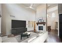 Spacious living room features a stone fireplace, high ceilings, and hardwood floors at 2264 S Joyce St, Lakewood, CO 80228