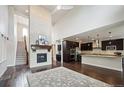 Open concept living space featuring a fireplace and modern kitchen at 2264 S Joyce St, Lakewood, CO 80228
