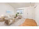 Bright living room with hardwood floors, a large window, neutral furniture and decor at 9917 Garland Dr, Broomfield, CO 80021