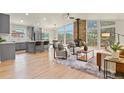 Open-concept living room featuring a stone fireplace and large windows at 30221 Stagecoach Blvd, Evergreen, CO 80439