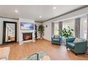 Cozy living room featuring a fireplace, hardwood floors, and lots of natural light at 6979 E Fremont Ave, Centennial, CO 80112