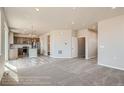 Open-concept living area showcasing a seamless transition to the modern kitchen and stylish light-colored floors at 2387 Bristol St, Superior, CO 80027