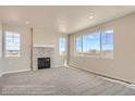 Bright living room with a cozy fireplace and large windows offering plenty of natural light at 2387 Bristol St, Superior, CO 80027